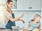 Mother and daughter, baking and smile with flour in kitchen and love by bonding. Happy family, fresh ingredients and fun in learning, cake and dessert or play for breakfast, snacks and food at home