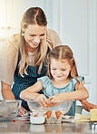 Mom, girl child and eggs in kitchen, development and skills with bonding, love or care in family house. Cooking, mother and daughter with smile, teaching and education by table, bowl or help for food