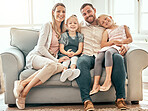 Smile, love and portrait of family on a sofa in the living room bonding and relaxing together at home. Happiness, care and girl children laying with parents from Australia on floor in the lounge.