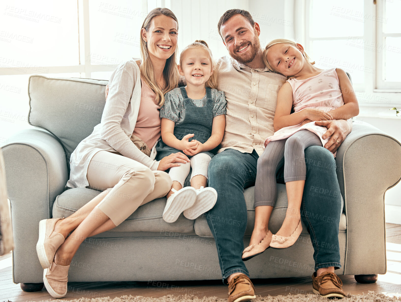 Buy stock photo Smile, love and portrait of family on a sofa in the living room bonding and relaxing together at home. Happiness, care and girl children sitting with parents from Australia on couch in the lounge.