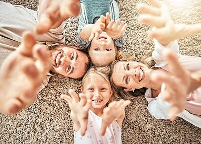 Buy stock photo Happy family, children and parents on floor, smile and happiness with hands, enjoying and playing. Morning, mom and dad with girls, home and bonding together in top view, playful and affectionate