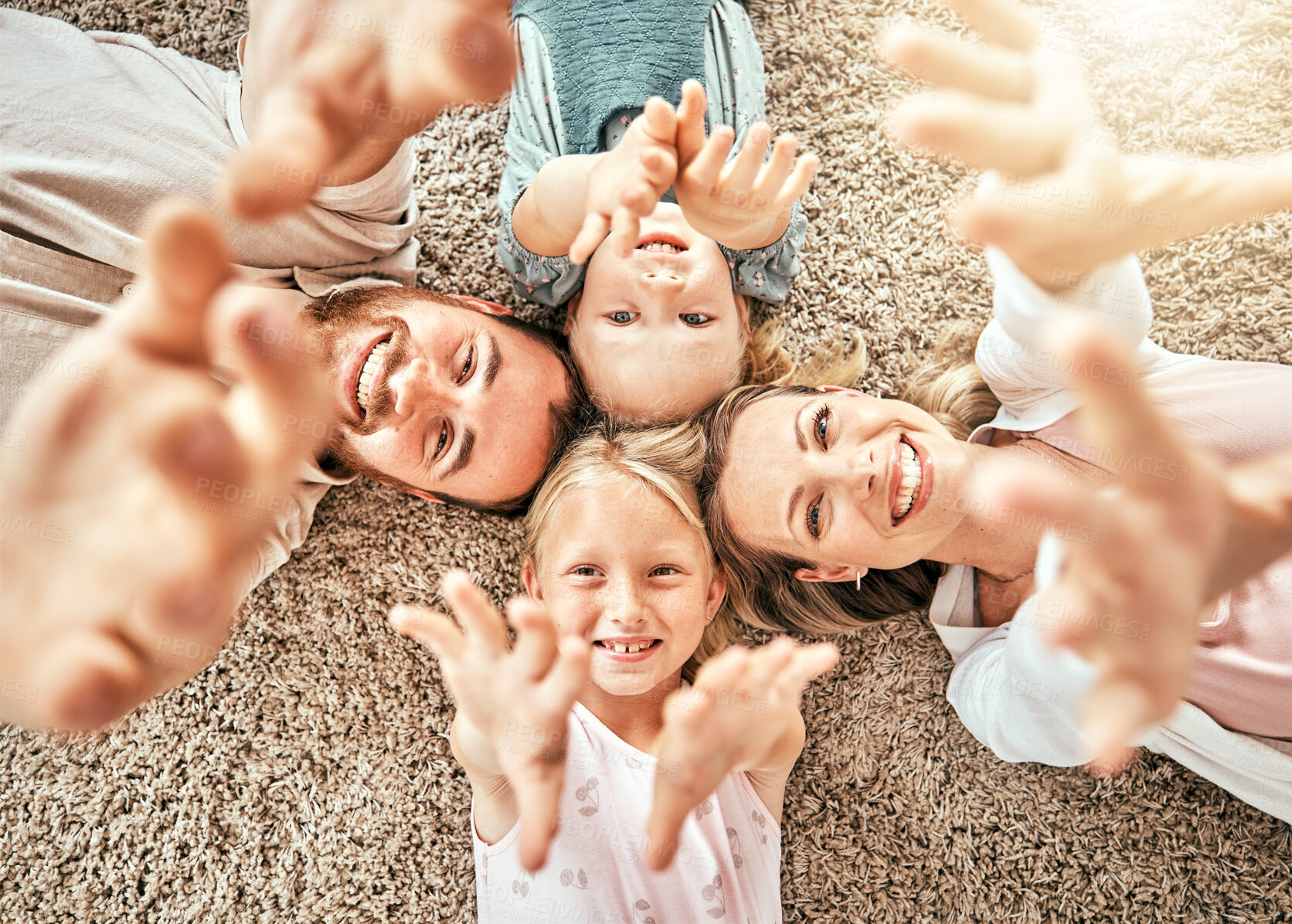 Buy stock photo Happy family, children and parents on floor, smile and happiness with hands, enjoying and playing. Morning, mom and dad with girls, home and bonding together in top view, playful and affectionate