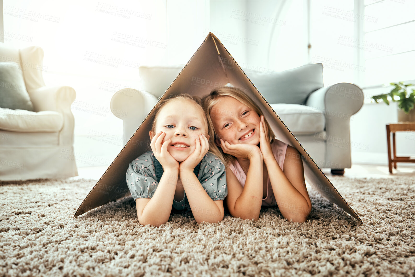 Buy stock photo Portrait, children and cardboard for insurance with girl sisters on the floor of the living room at home. Security. family or kids and young siblings on a carpet in their house for safety with flare