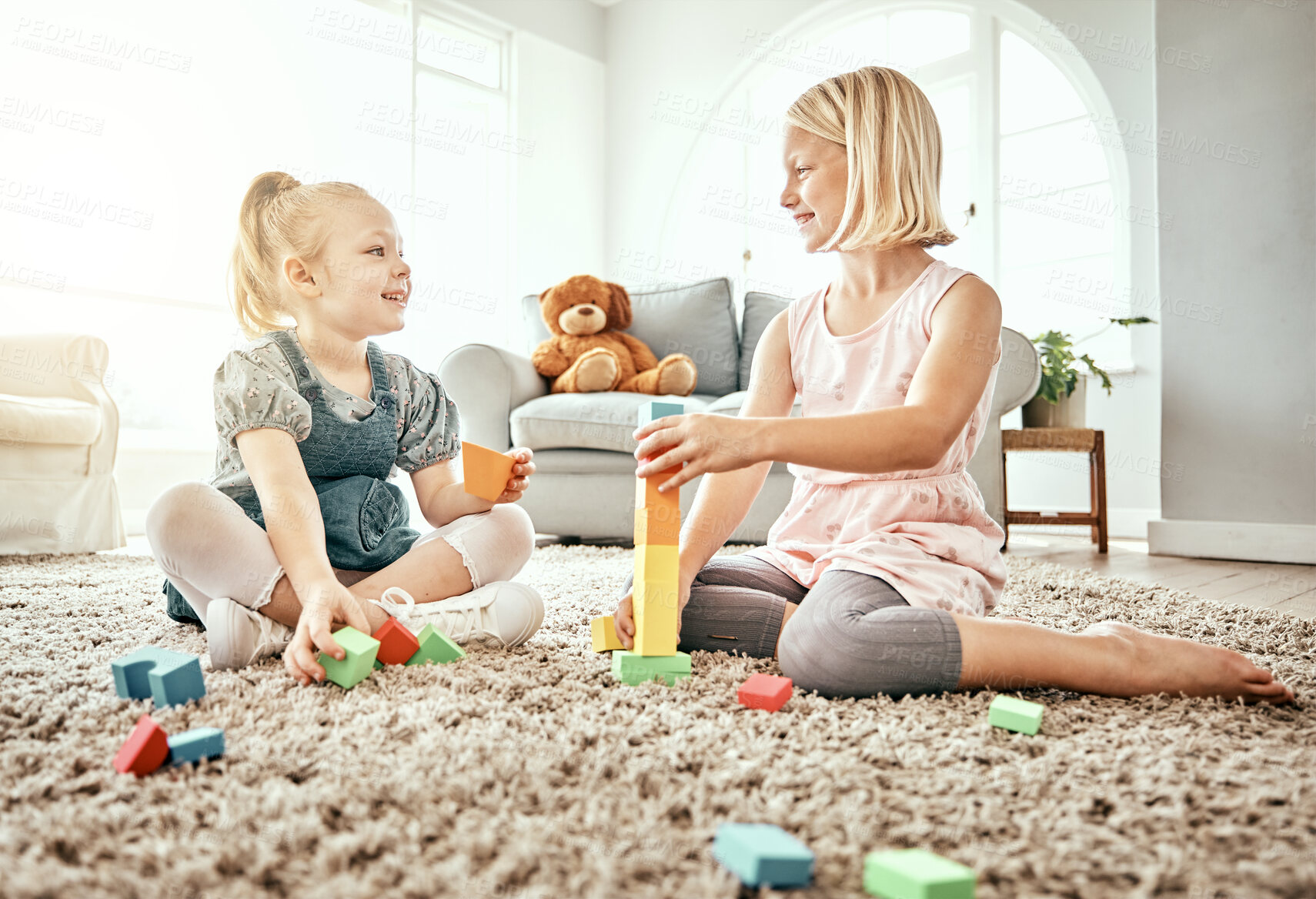 Buy stock photo Children, playing and toys on living room floor, home and bonding together, fun and child development. Building blocks, sisters and learning for creativity with activity, relax indoors and happiness