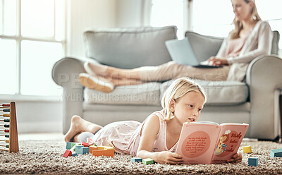 Buy stock photo Girl child, home and reading book for learning, language development and mother work from home in living room. Family, kid and English story, school education and relax on floor with mom on sofa