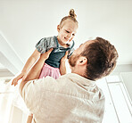 Family, children and a father carrying his girl daughter in the living room of their home together closeup. Smile, love or kids with a happy young child and her man parent having fun in their house