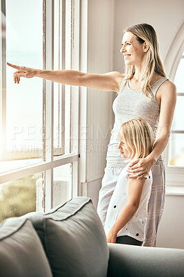 Buy stock photo Window, pointing and mother with girl in home looking outdoors for bonding, relationship and relax. Happy family, house and mom with child in living room for scenic view on weekend, morning and fun