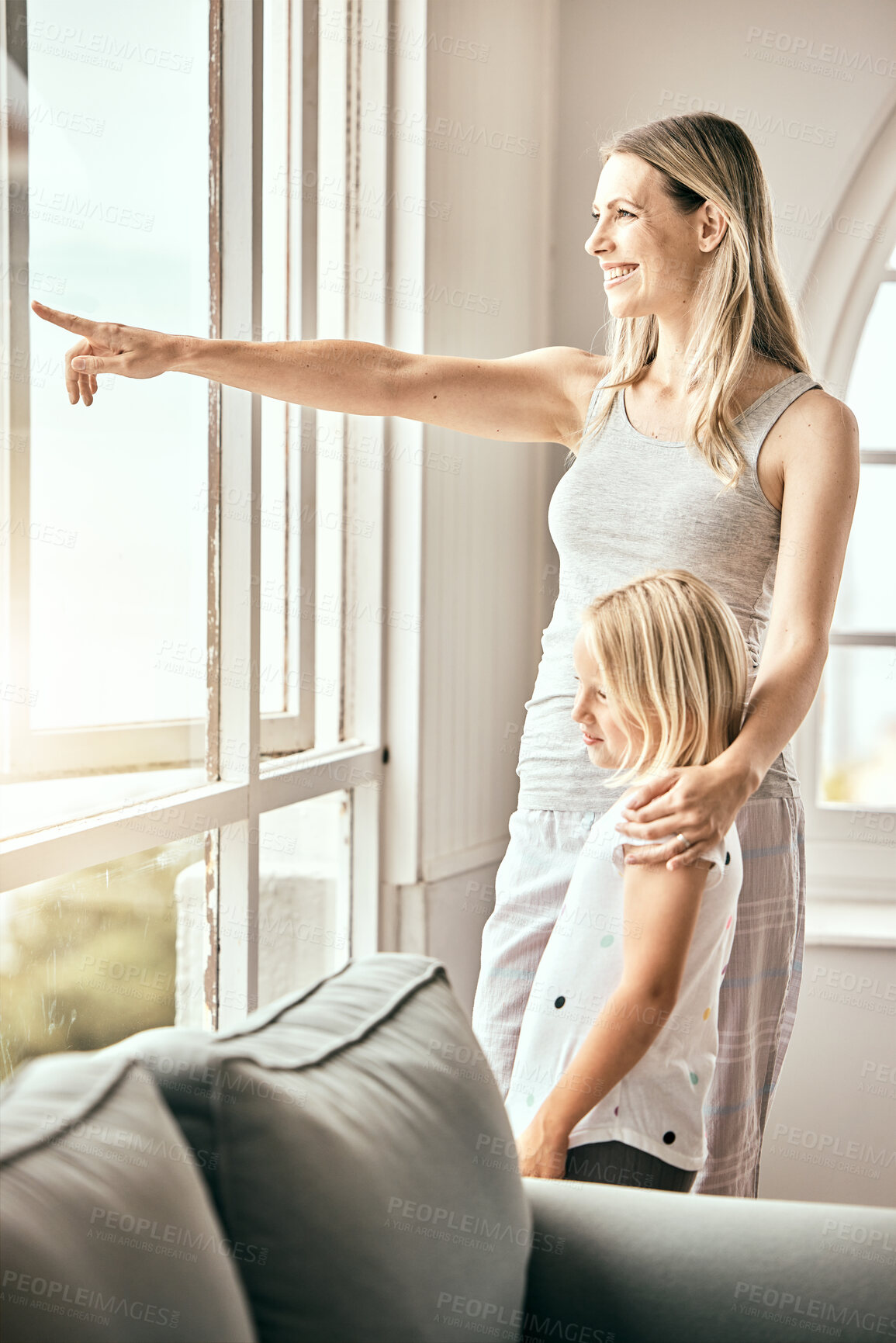 Buy stock photo Window, pointing and mother with girl in home looking outdoors for bonding, relationship and relax. Happy family, house and mom with child in living room for scenic view on weekend, morning and fun