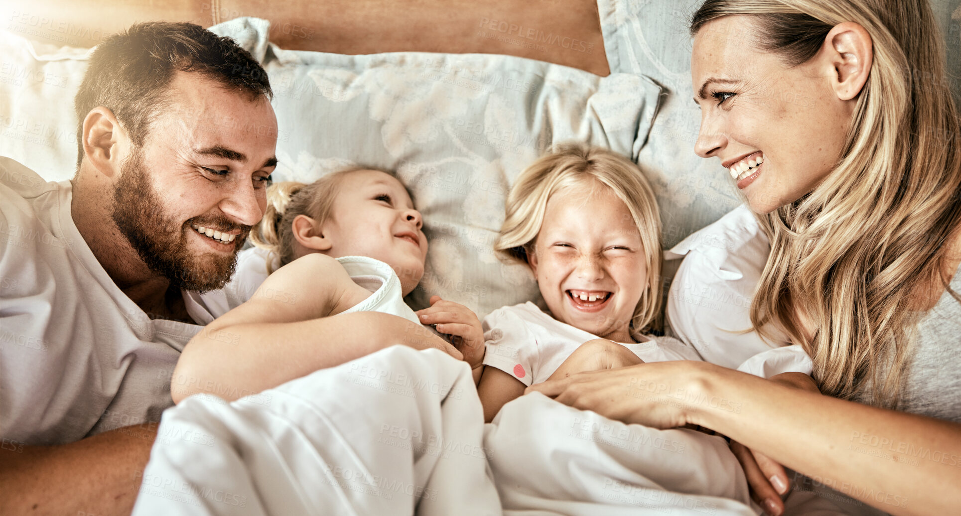 Buy stock photo Top view, bed and happy family bond with tickle, games and laughing in their home together. Bedroom, fun and above parents with girl kids in a house with care, support and love, security or playing