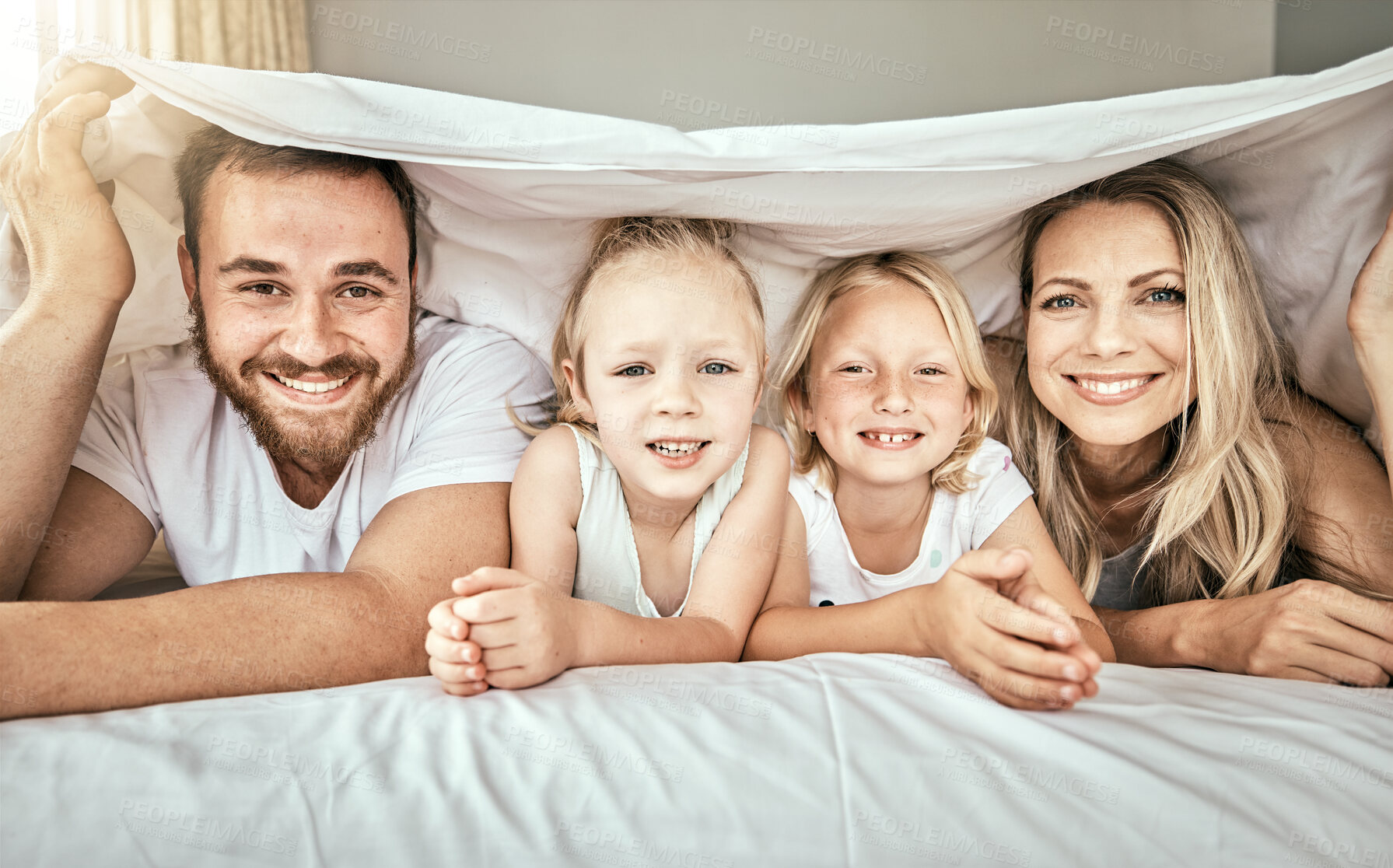 Buy stock photo Happy, smile and portrait of family on the bed with blanket for bonding and relaxing together at home. Happiness, love and girl children laying with parents from Australia in bedroom at modern house.