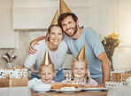 Portrait of parents, girl children and birthday cake for celebration with candles, love and sweets in home. Happiness, face of mother and father together at table at happy kids party event in house.