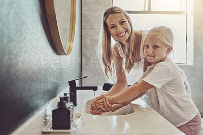 Buy stock photo Bathroom, mother and child cleaning hands with water, soap or learning healthy hygiene in portrait together. Washing dirt, germs or bacteria on fingers, mom and girl in home with smile, help and care