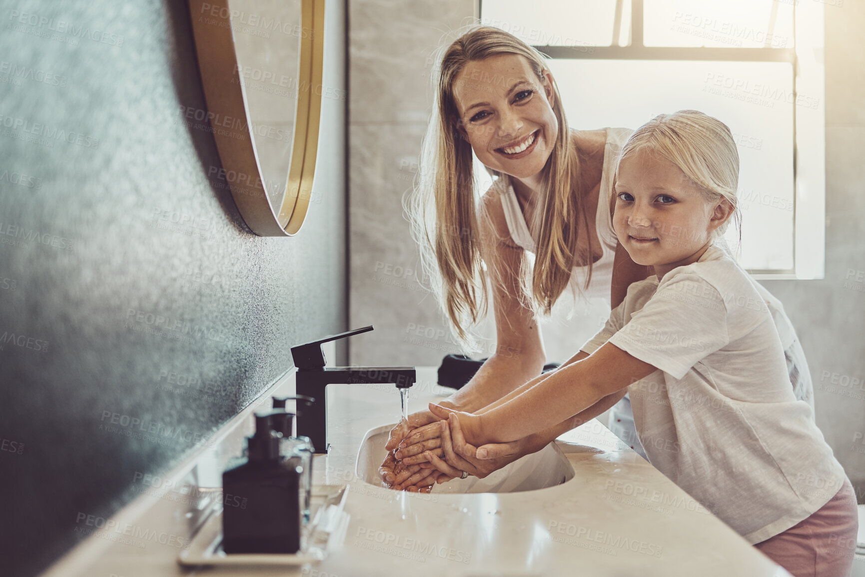 Buy stock photo Bathroom, mother and child cleaning hands with water, soap or learning healthy hygiene in portrait together. Washing dirt, germs or bacteria on fingers, mom and girl in home with smile, help and care