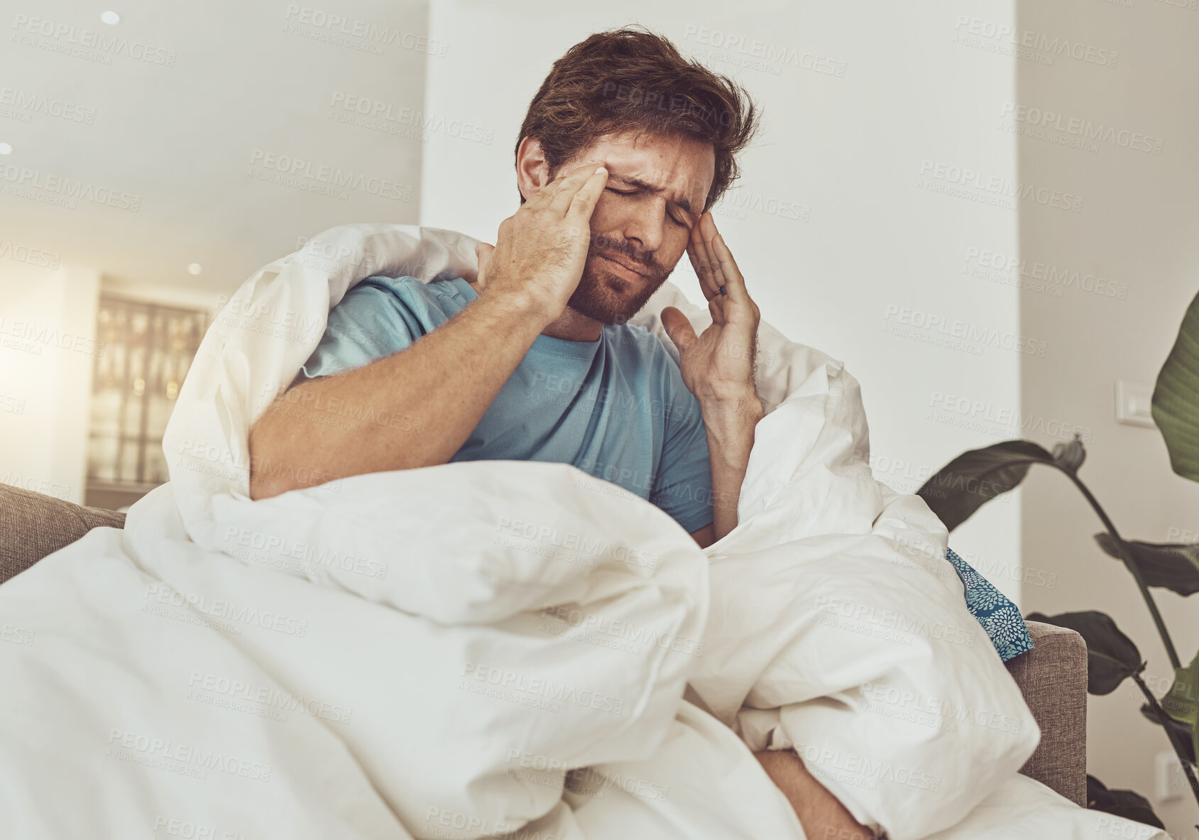 Buy stock photo Stress, headache and sick man on a sofa with burnout, vertigo or pain from insomnia at home. Anxiety, migraine and male person in a lounge with temple massage for dizziness, congestion or head cold