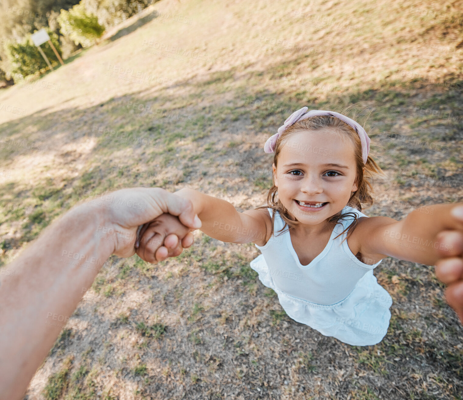 Buy stock photo Happy, pov and hands swing child outdoor in garden, park or game in nature with parent. Girl, face and dad or mom swinging kid for crazy, fun or bonding in summer, vacation or backyard games