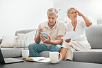 Frustrated senior couple, documents and debt on living room sofa in financial crisis, expenses or bills at home. Mature man and woman checking finance, paperwork or budget with calculator for invoice