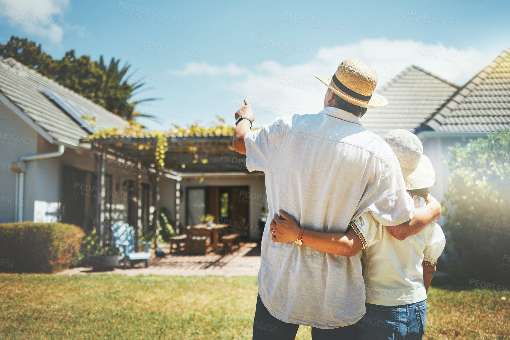 Buy stock photo Back view, couple and pointing outdoor at new home, real estate or house investment. Man, woman and hug at front of property for moving together in building, dream neighborhood and mortgage at garden