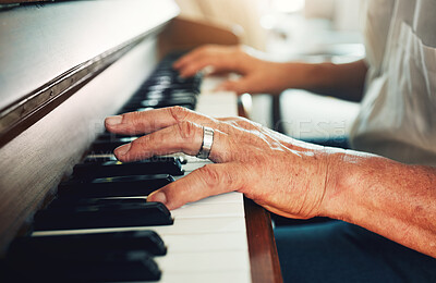 Buy stock photo Hands, piano and senior man playing for music in living room for musical entertainment practice. Instrument, hobby and elderly male person in retirement enjoying a song on keyboard at modern home.