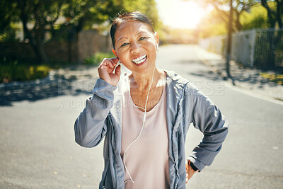 Fitness, earphones and portrait of happy Asian woman outdoor for sports training, exercise and healthy body. Face, mature athlete listening to music in street and streaming audio podcast to workout