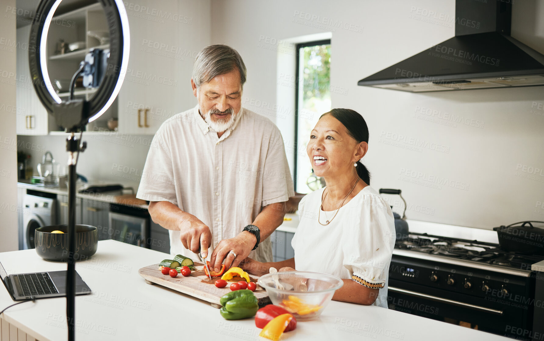 Buy stock photo Home, senior couple or influencer with food, smile or live streaming with connection, ring light or tech. Vlog, elderly man or old woman with social media, kitchen or cooking with diet plan or health