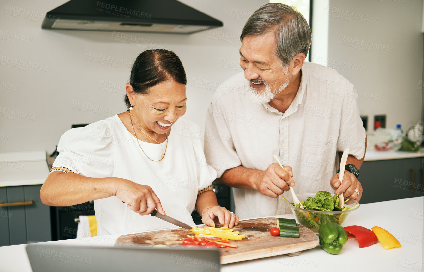 Buy stock photo Happy couple, together and cooking of meal in kitchen for dinner with preparation, vegetables and salad. Asian, elderly and people with care, love and bond in home for health, wellness or nutrition