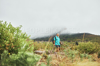 Buy stock photo Old man, hiking with nature and exercise, travel and walking in field or bush for health and wellness outdoor. Adventure, trekking and fitness, mockup space and freedom with retirement activity