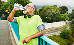 Hiking, drinking water or senior man in nature for trekking journey or adventure for resting or break. Relax, hydration or mature hiker in park or woods for exercise, fitness workout or wellness 