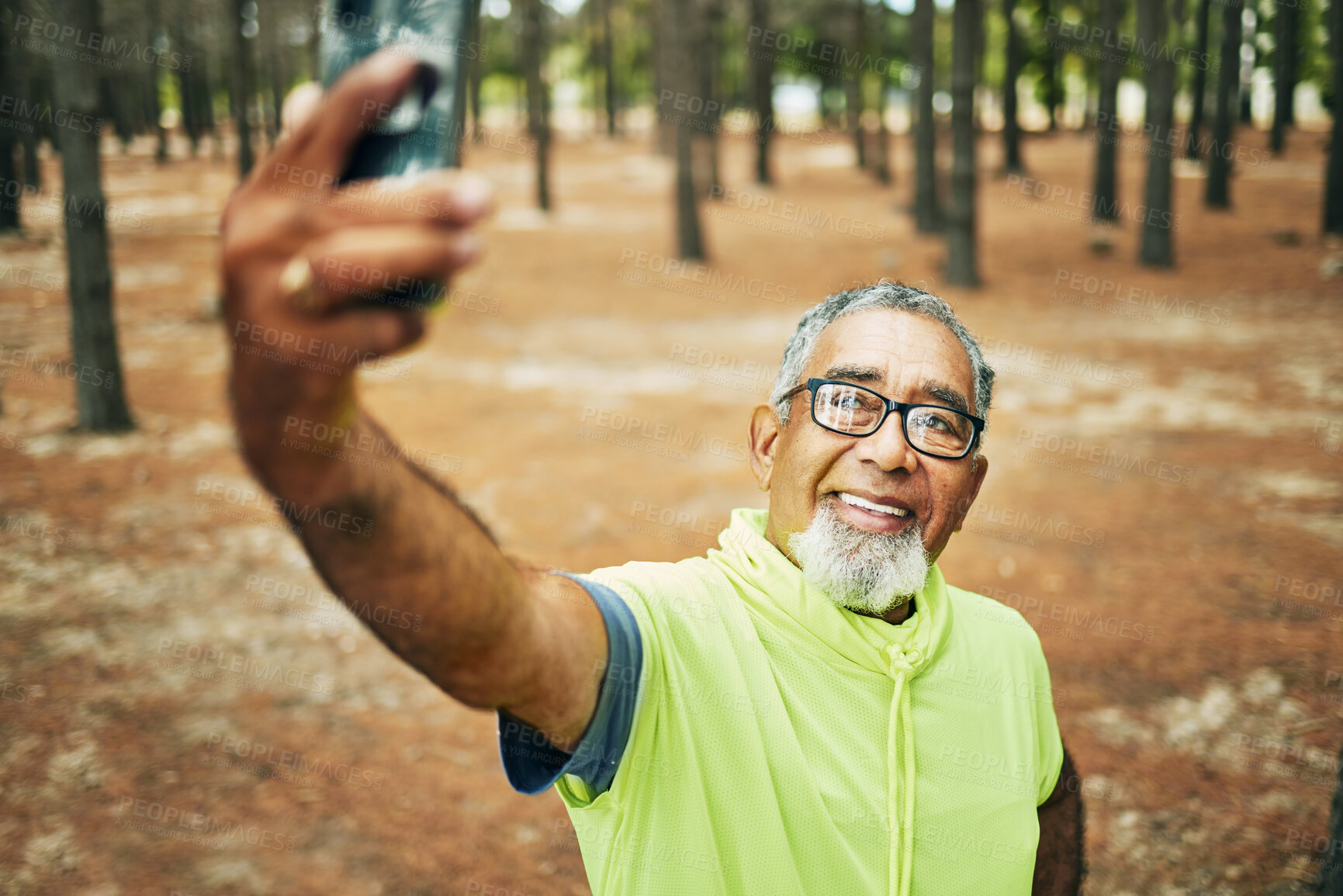 Buy stock photo Selfie, smile and senior man hiking for health, wellness or cardio training on a mountain. Happy, nature and excited elderly male person taking a picture on cellphone for outdoor trekking in woods.