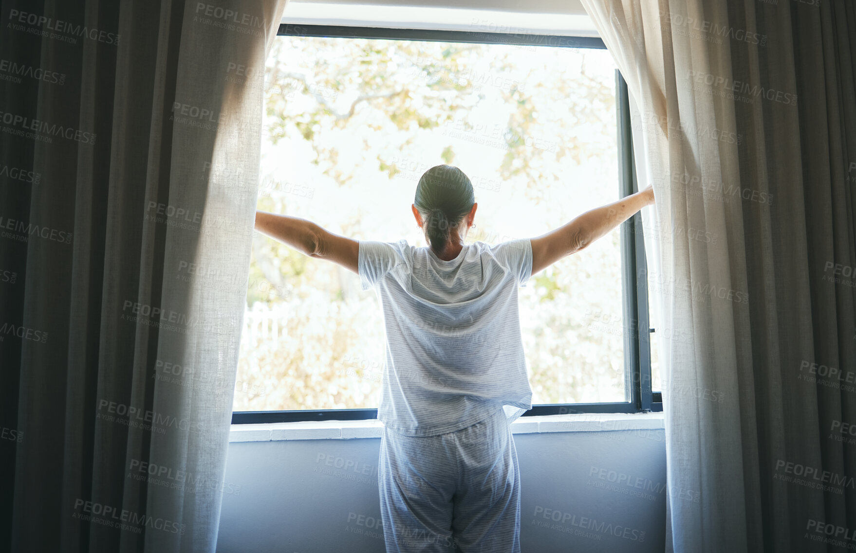 Buy stock photo Open, curtains and back of woman at window for wake up, sunrise and good morning routine in bedroom at home. Awake, drapes and light of sunshine for inspiration, relaxing view or start bright new day