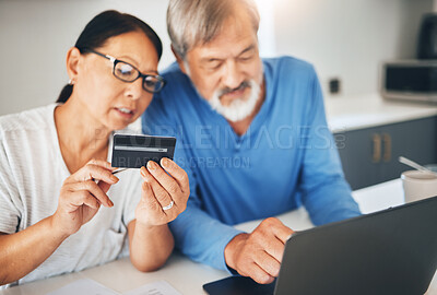 Buy stock photo Mature couple, credit card and laptop for home online shopping, loan application or financial management in kitchen. Man and woman with computer for internet banking, security numbers or registration