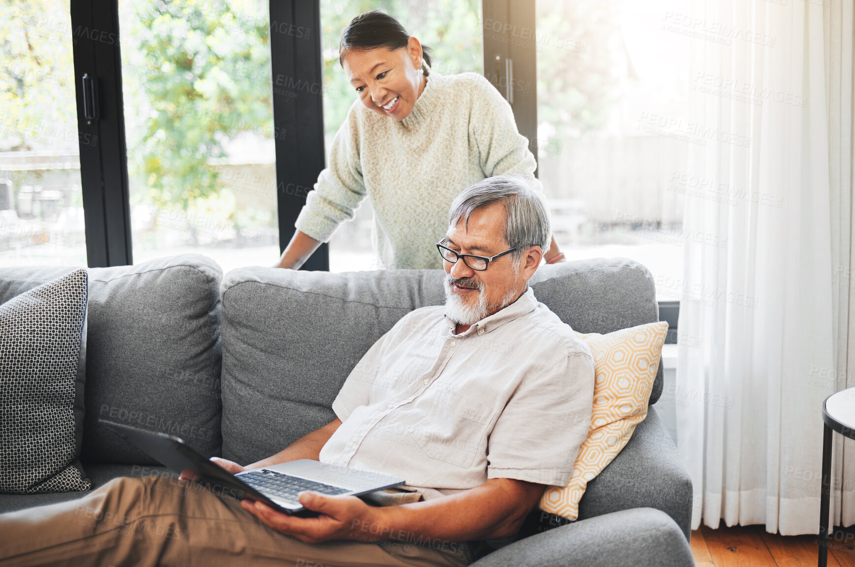 Buy stock photo Laptop, happy and mature couple on sofa in home, online shopping and streaming video on internet together. Computer, Asian man and woman smile in living room on website, social media or communication