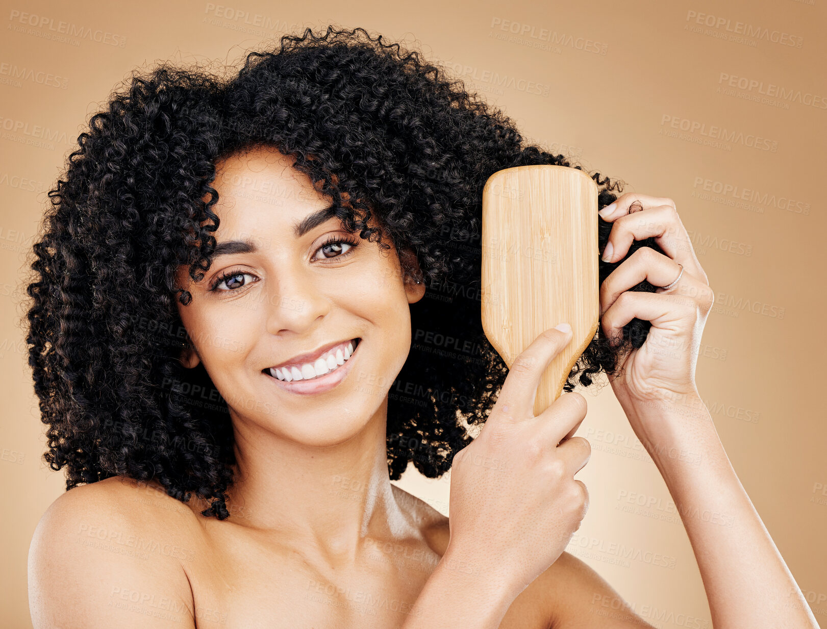 Buy stock photo Woman, portrait and brush hair, curly with shine and beauty, smile for salon treatment and strong texture on studio background. Face, skin and growth, haircare and cosmetology with cosmetic tools