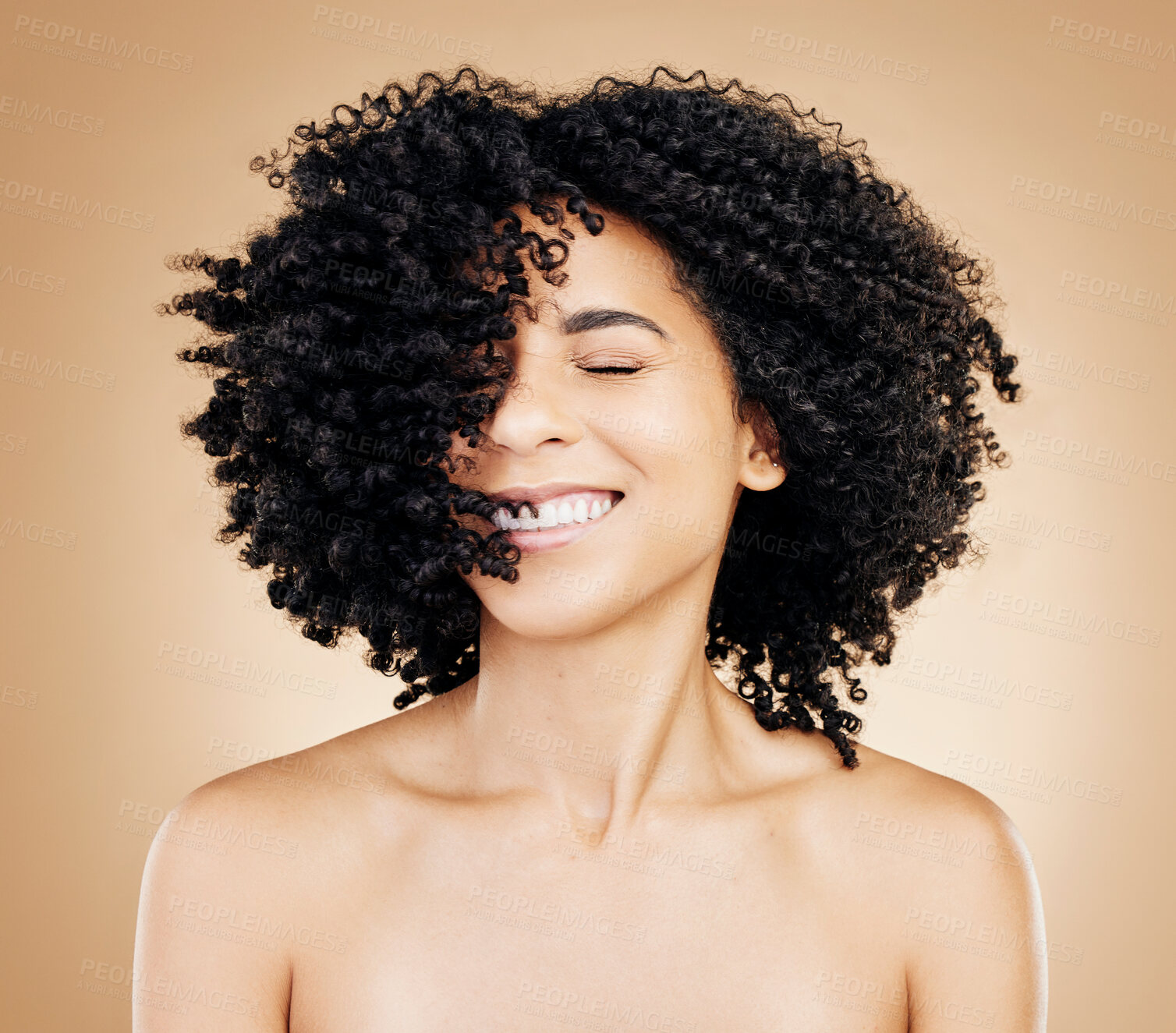 Buy stock photo Happy woman, curly or afro hair wind on fun studio background for healthy hairstyle growth, texture or frizz treatment. African beauty model, shake energy and change by shampoo transformation results