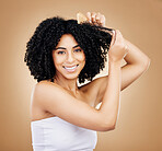 Afro, hair comb and portrait of woman in studio for beauty, natural growth and grooming on brown background. Happy model brush curly hairstyle texture for salon aesthetic, keratin treatment and care 