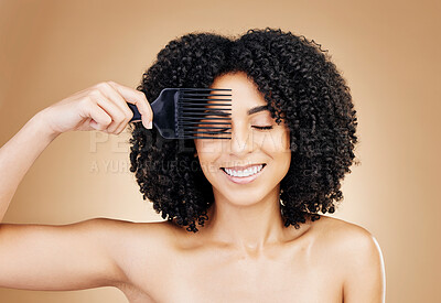 Buy stock photo Hair, comb and happy woman with afro as style isolated in a studio brown background for wellness and skincare. Texture, natural and young person with cosmetic aesthetic in Brazil hairdresser