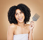 Hair, beauty and woman thinking  with comb for style isolated in a studio brown background for wellness and skincare. Texture, natural and young person with cosmetic aesthetic in Brazil hairdresser