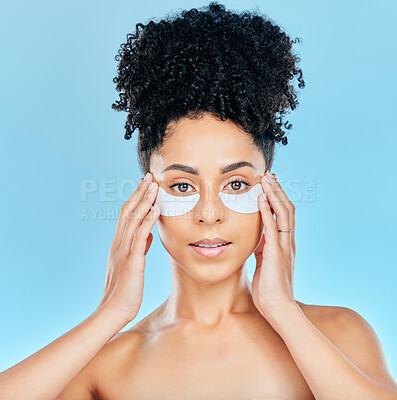 Buy stock photo Portrait, woman and face with eye patch application for skin hydration glow, wellness or feel smooth beauty results. Spa salon, studio cosmetic or anti aging model with facial mask on blue background