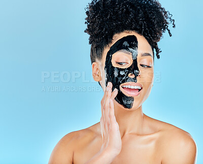 Buy stock photo Skincare, face mask and woman in studio for charcoal facial treatment, anti aging and wellness. Beauty salon, dermatology and face of person for health, cosmetics or grooming on blue background