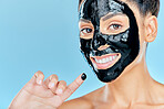 Beauty, charcoal face mask and portrait of woman for facial treatment, anti aging detox and wellness. Skincare, studio and person with products for health, cosmetics or grooming on blue background