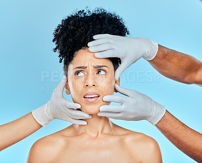 Buy stock photo Skincare, plastic surgery and fear, woman with hands on face in studio for cosmetic consultation. Model with stress, worry and anxiety for beauty, dermatology or collagen therapy on blue background.