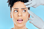 Beauty, plastic surgery and scared woman with hands on face in studio for cosmetic facial consultation. Skincare, dermatology and professional collagen therapy, model on blue background with fear.