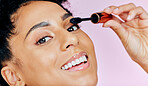 Closeup, happy woman and mascara for makeup in studio with mock up in cosmetics on pink background. African, female model and smile in portrait for beauty, treatment and confidence with application