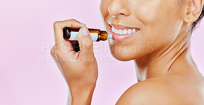 Buy stock photo Closeup, woman and beauty with lip balm in studio with mockup for treatment on pink background to hydrate. Female model, smile and cosmetic for dermatology with omega 3, vitamin c and hyaluronic acid