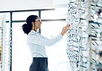 Optometry store, glasses shelf or happy woman for lens frame decision, shop choice or eyewear sales. Eye care, vision eyesight support or retail client, customer or optometrist for optical eyeglasses