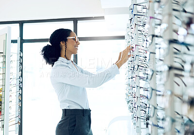 Buy stock photo Store shelf, glasses choice or happy woman for lens frame decision, optometry shop or eyewear sales. Eye care, vision eyesight support or retail client, customer or optometrist for optical eyeglasses