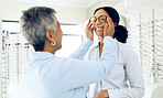 Optometry, glasses and women consulting for decision, choice and eye care option in optician store. Healthcare, ophthalmology and people in clinic for prescription lens, spectacles and vision frames