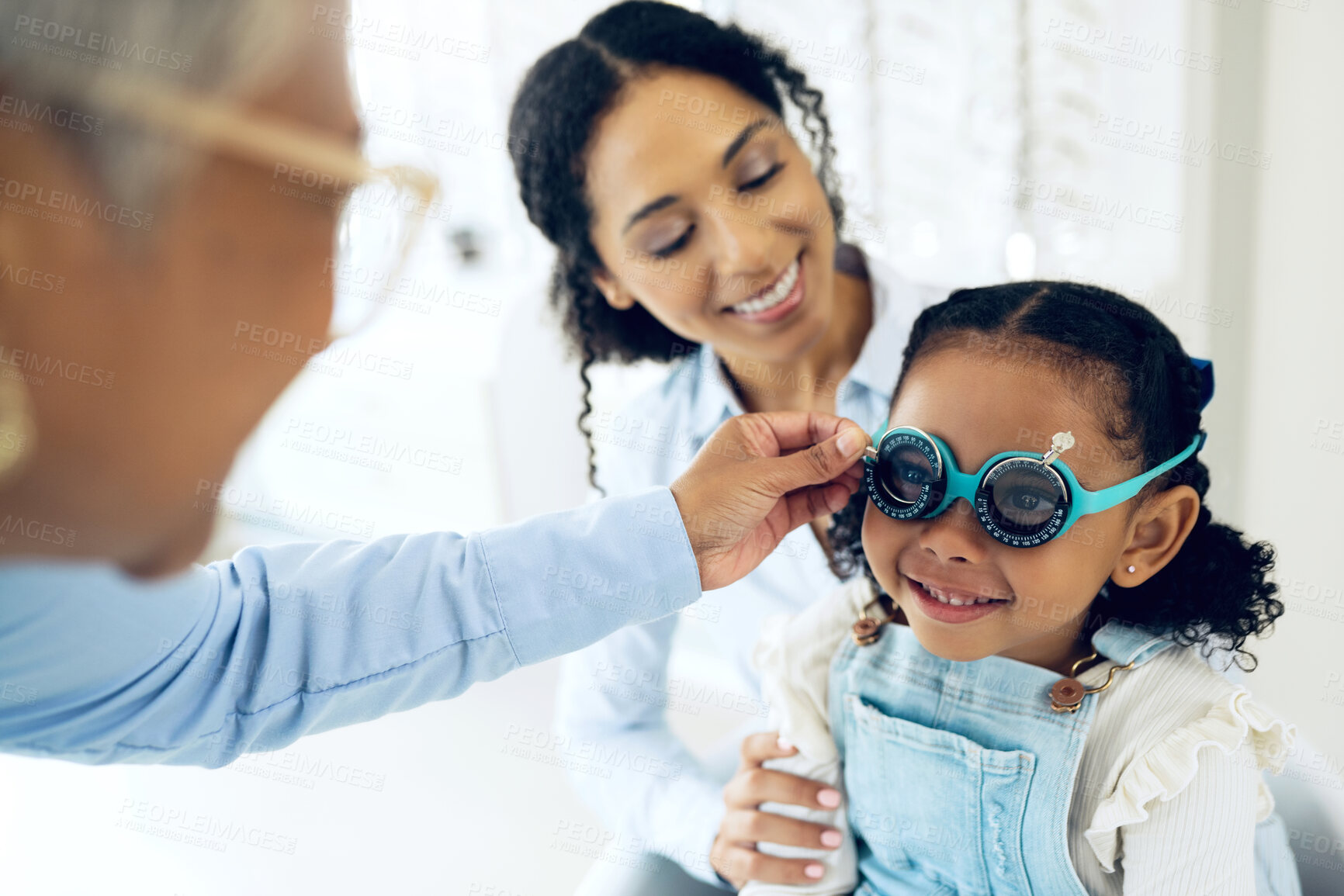 Buy stock photo Trial lens, optometry and optometrist with child and mother at eye care appointment for vision test. Health, medical and senior optician with mom and girl kid patient with tool in an optical clinic.