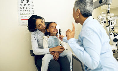 Buy stock photo Eye exam, optical and optometrist with child and mother at an eye care appointment for vision test. Health, wellness and senior optician with mom and girl kid patient with lenses in optometry clinic.