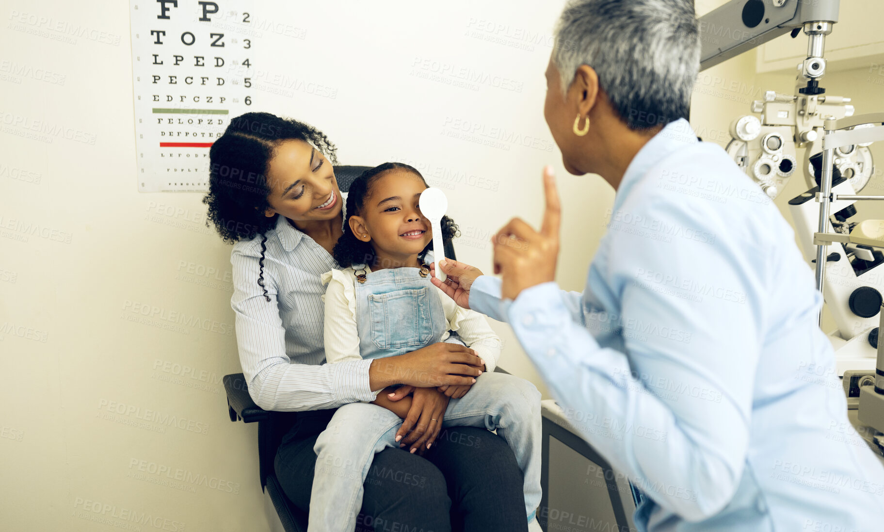 Buy stock photo Eye exam, optical and optometrist with child and mother at an eye care appointment for vision test. Health, wellness and senior optician with mom and girl kid patient with lenses in optometry clinic.