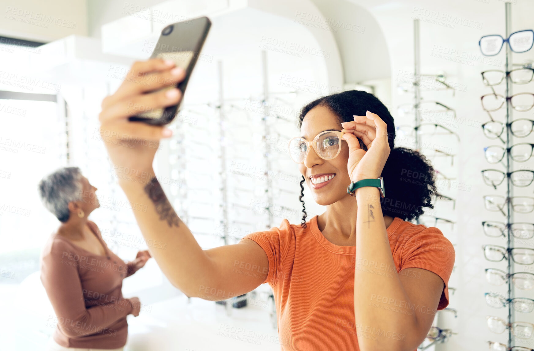 Buy stock photo Selfie, optometry and woman trying glasses with prescription lenses and frame in an optical store. Vision, smile and young female person taking a picture on a phone for choosing spectacles in clinic.